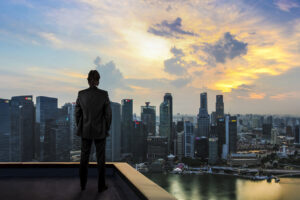 Businessman watching the city on the rooftop of skyscraper Businessman watching the city on the rooftop of skyscraper